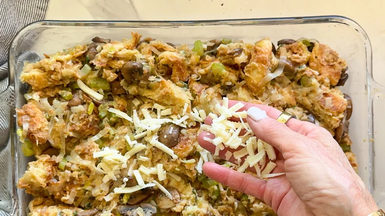 hand adding cheese