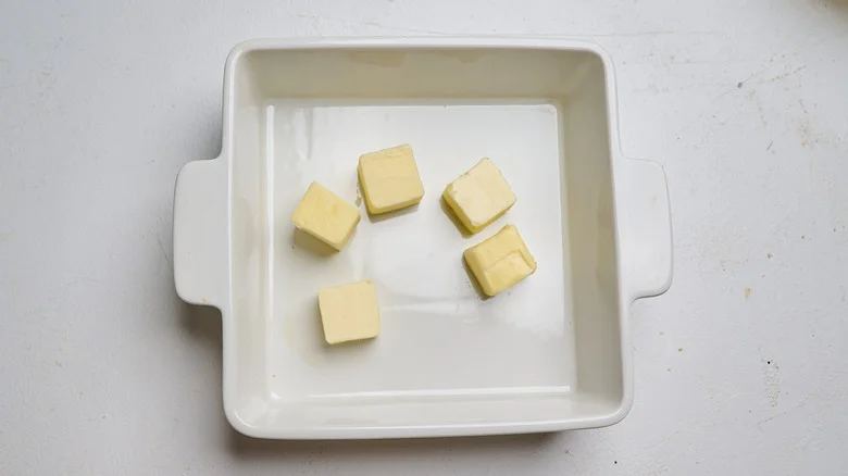 butter pats in a baking dish