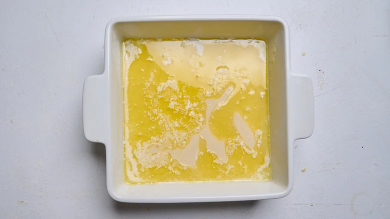 batter poured into baking dish with butter