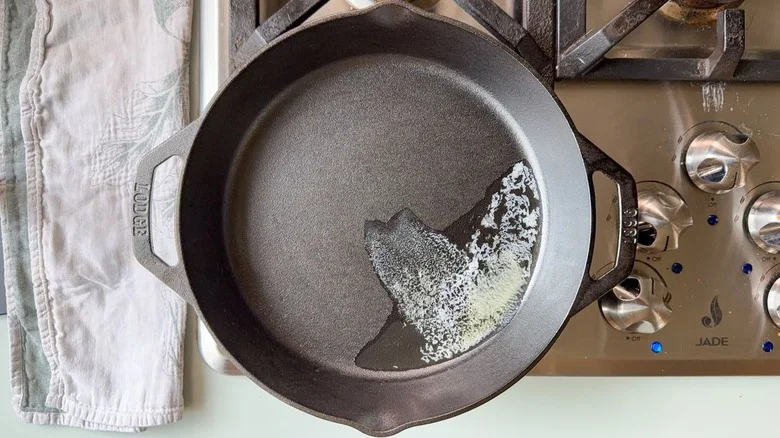 Butter melting in cast iron skillet on stovetop