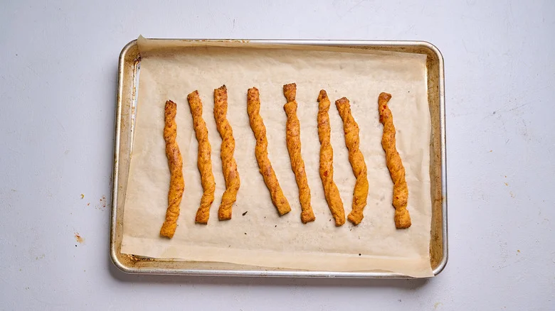 baked cheese straws on a sheet tray