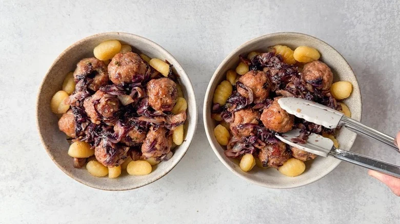 Serving fig and gorgonzola meatballs with radicchio over crispy gnocchi in serving bowls