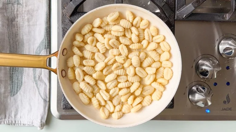Potato gnocchi in large skillet on stovetop