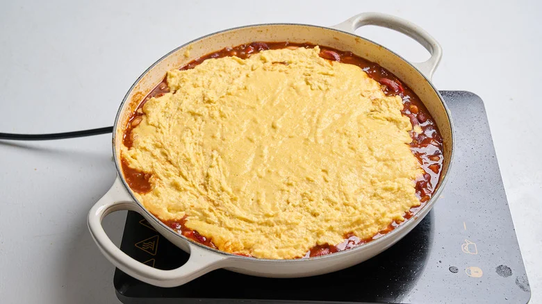 cornbread topping spread across casserole