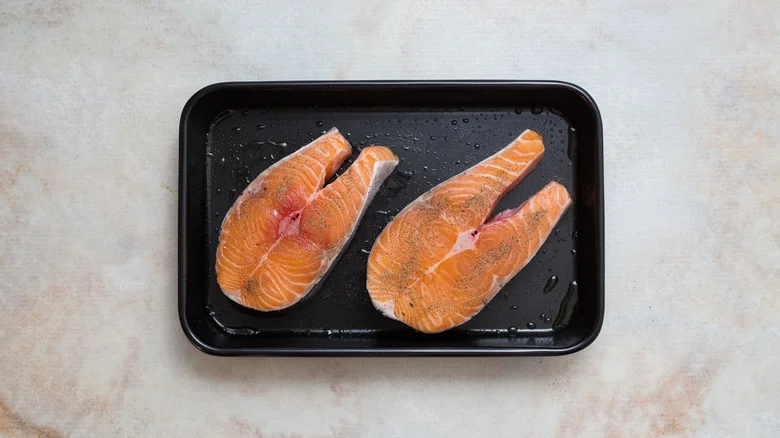 raw salmon steaks in pan