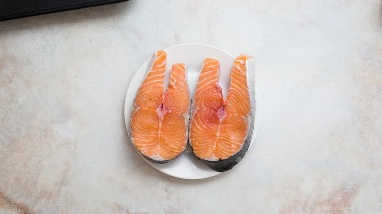 raw salmon steaks on plate