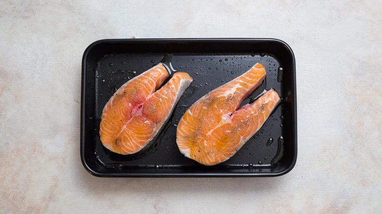 raw salmon steaks in pan