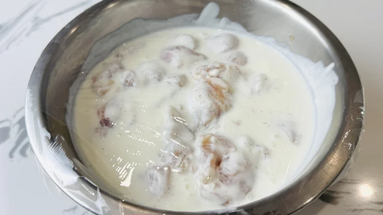 Buttermilk coated in chicken in bowl
