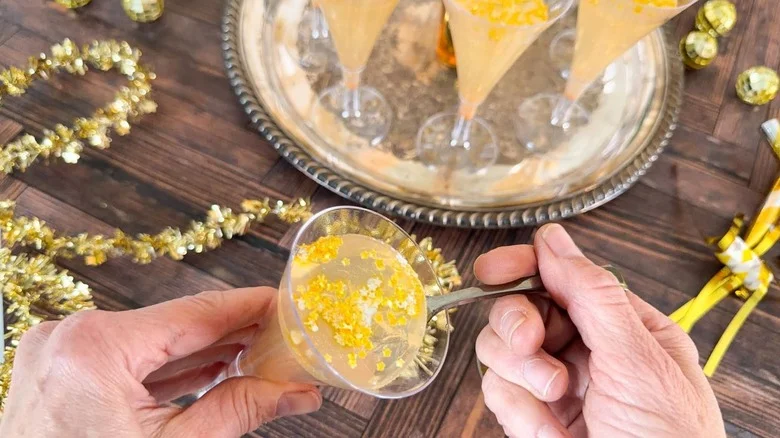 Champagne jell-o shot with edible gold stars in mini flute