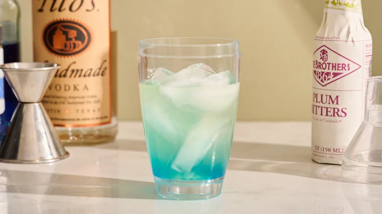 cocktail shaker filled with ice and liqueur