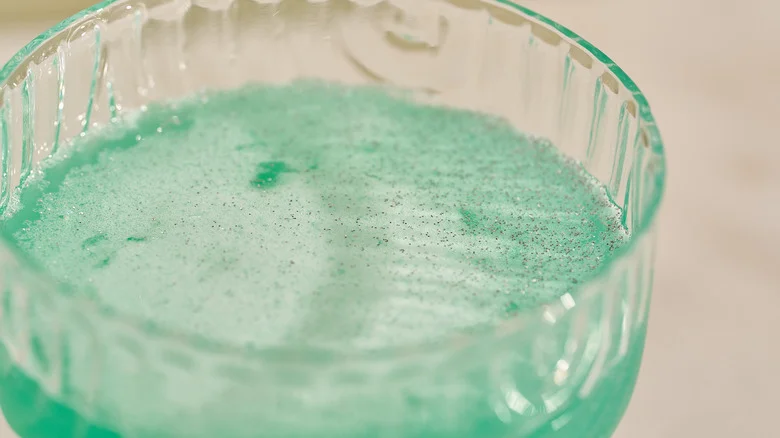 glitter on top of green cocktail