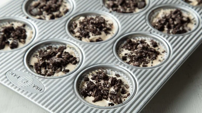 ice cream and cookie pieces in muffin cups