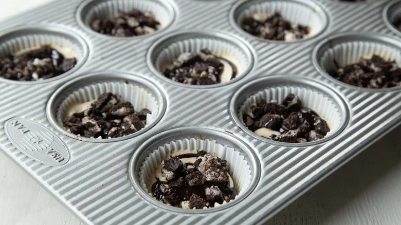 ice cream, cookies, and fudge sauce in muffin cups