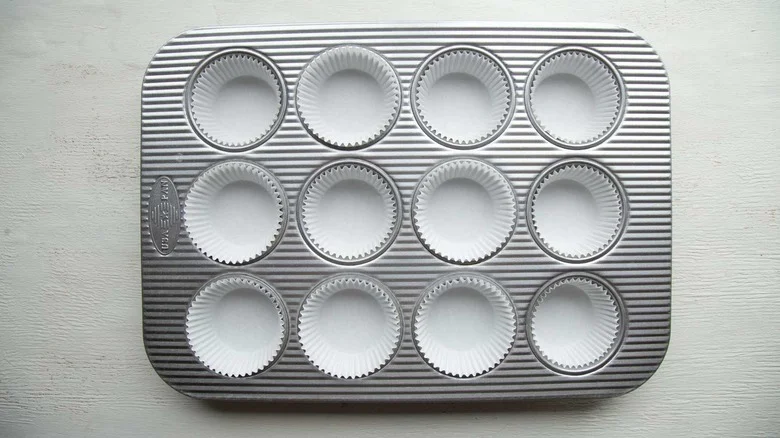 muffin pan with white paper liners