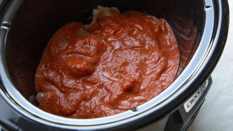 tomato chipotle sauce coated chicken thighs in slow cooker