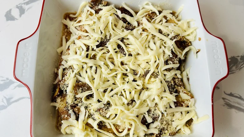 chicken with mushrooms and cheese in a white pan