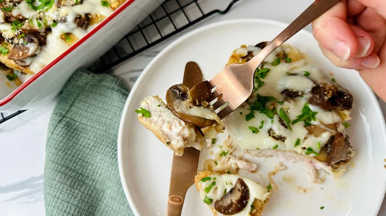 Bite of chicken Lombardy on fork