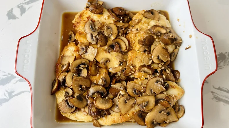 chicken with mushroom sauce in a white pan