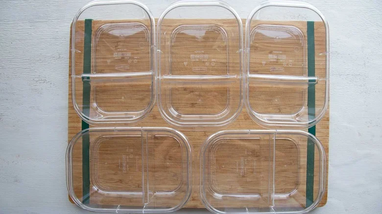 five meal prep containers on counter