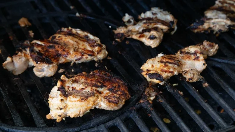 grilled chicken thighs cooking on grill
