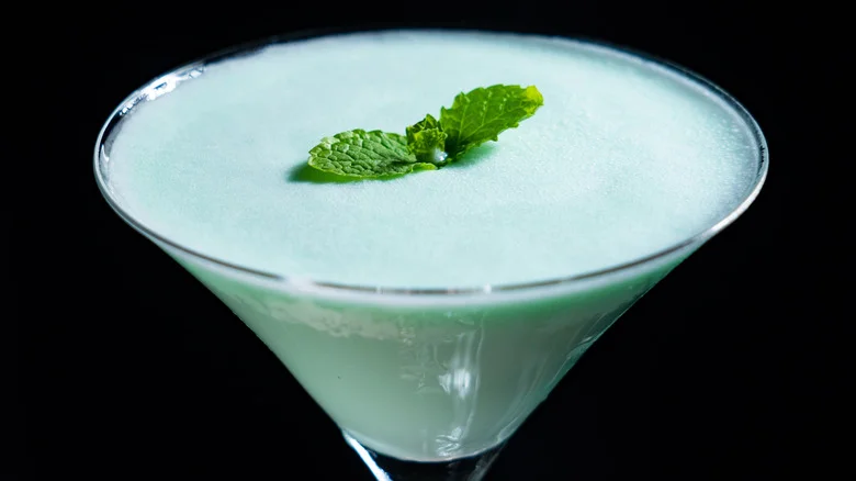 Pale green grasshopper cocktail garnished with two mint leaves