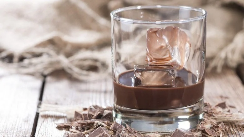 Little black dress cocktail in a short glass with two large ice cubes