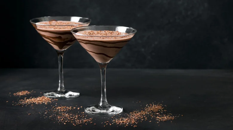 Two chocolate truffle martinis in glasses, showing chocolate layering