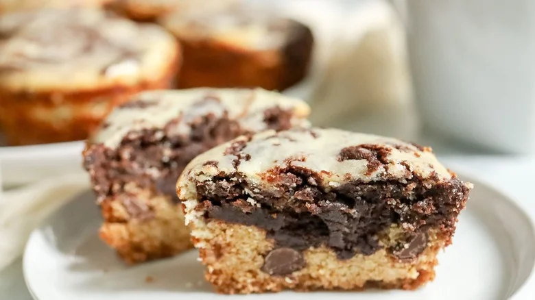 Cheesecake brookie muffin halved on plate