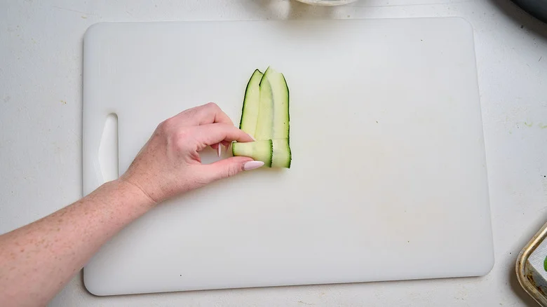 rolling zucchini around filling