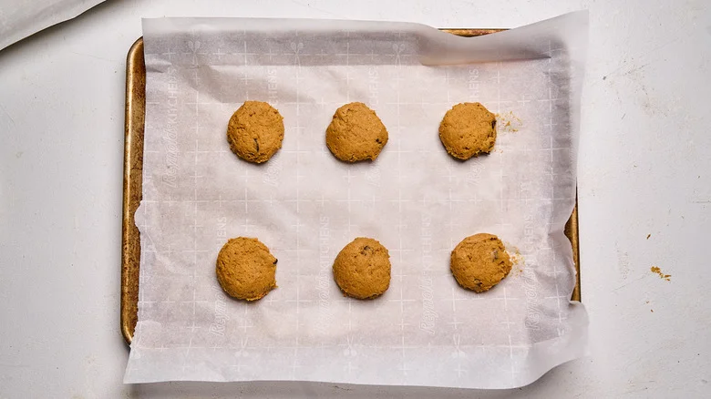 dough pressed into discs on a sheet tray