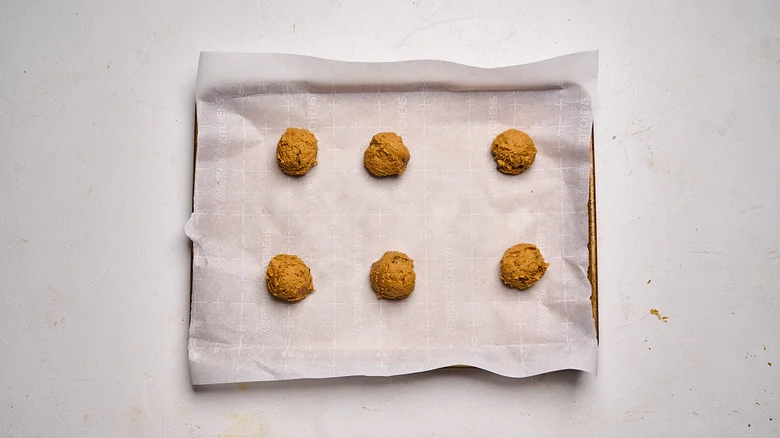 dough balls on a parchment lined sheet tray