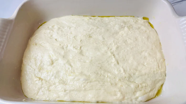 Focaccia dough in baking dish