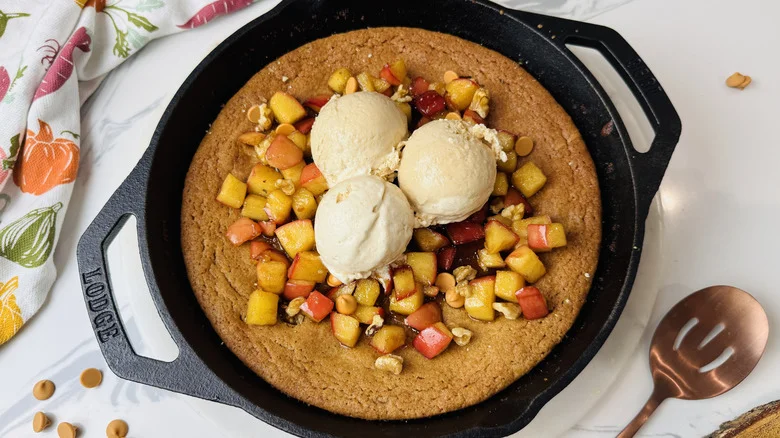 Apple skillet blondie topped with spiced apples and ice cream scoops