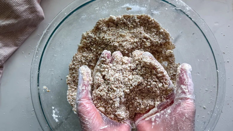 hands showing crumb mixture