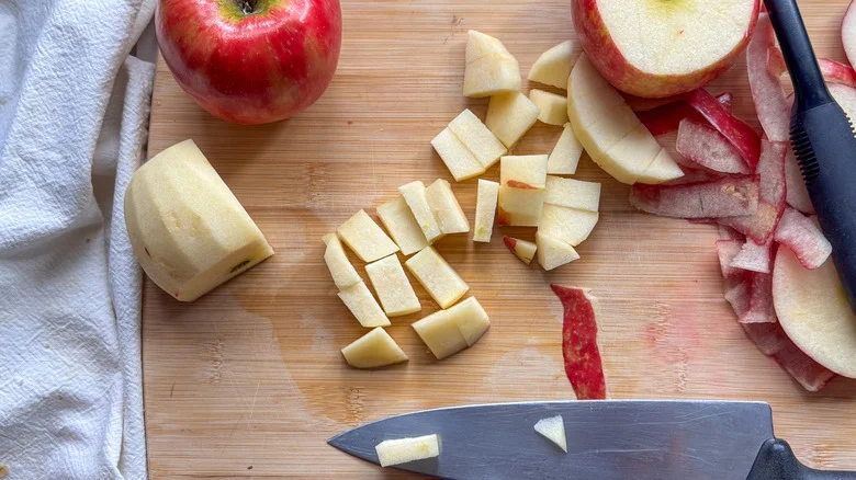 apples peeled and chopped on board