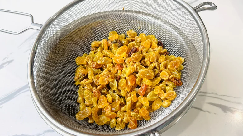 Golden raisins in mesh strainer