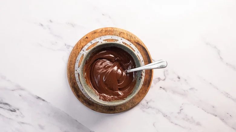 Chocolate ganache in bowl with spoon