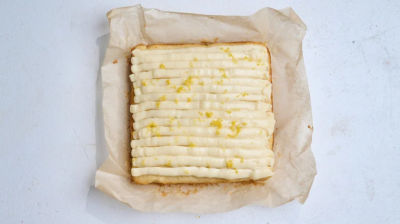 cake on a table topped with lemon zest