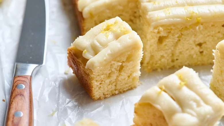 slices of cake on a table next to sheet cake