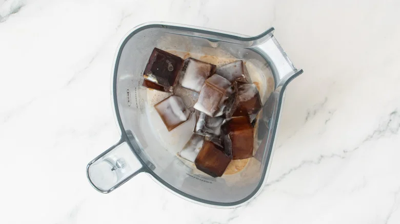Coffee ice cubes and milk in blender