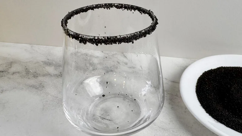 drinking glass rimmed with black salt