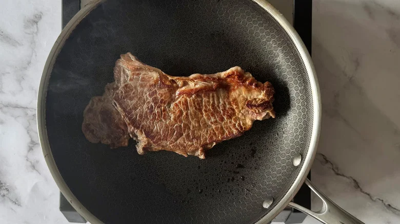 cooked steak in a frying pan