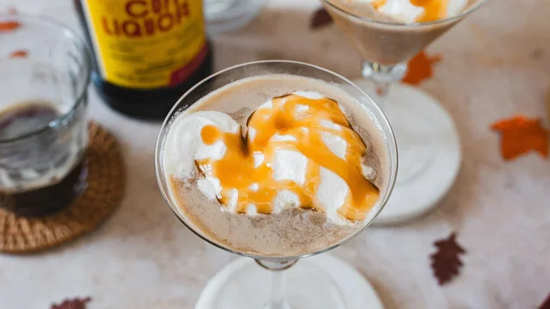 Top view of a caramel apple espresso martini with whipped cream and caramel drizzle.