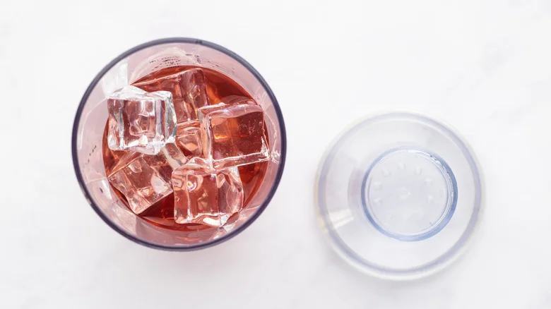 Raspberry lychee cocktail ingredients and ice in shaker