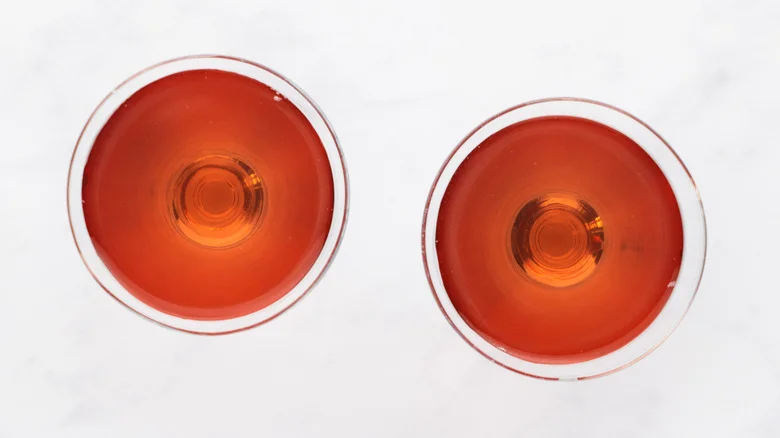 Top down view of two pink cocktails in glasses