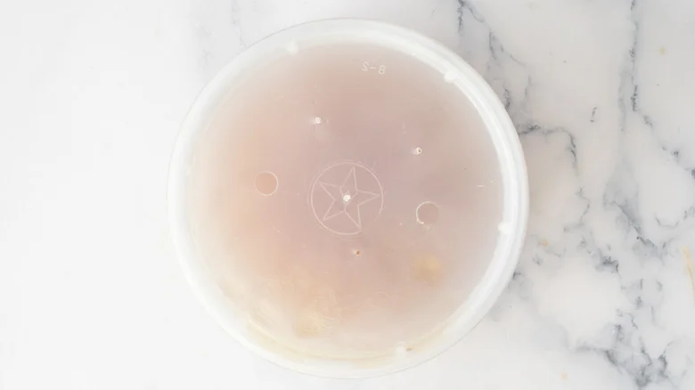 lidded cup with a star logo
