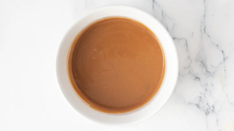 creamy brown sauce in a white bowl