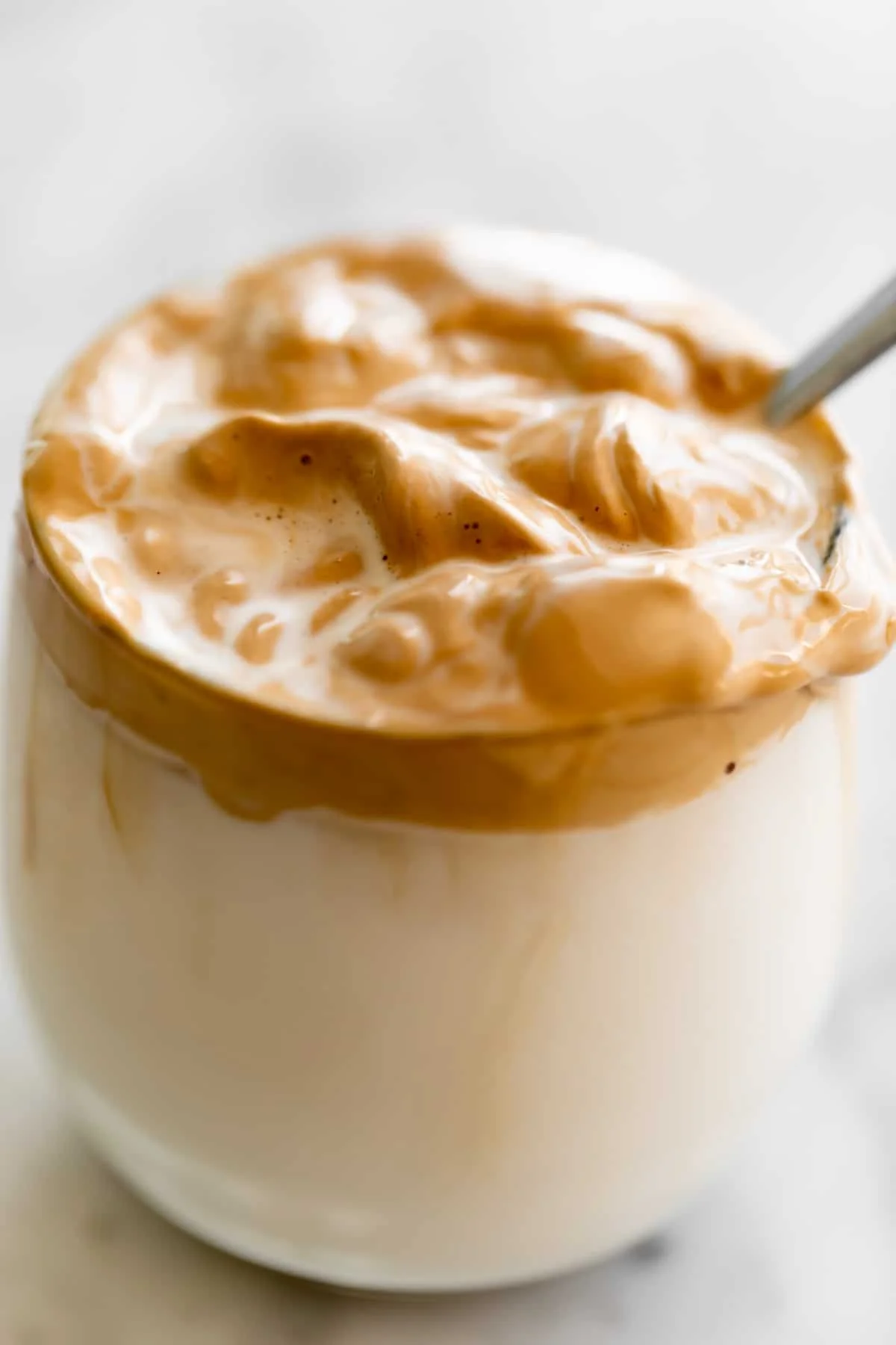 Whipped coffee mixed into a glass of milk.